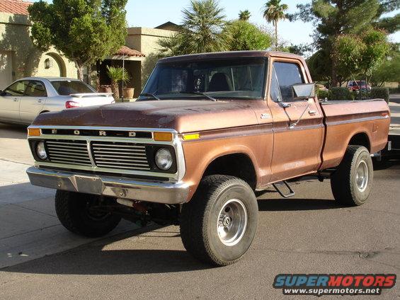 Brown 1977 Ford F-150 pickup truck with a chrome grille and front bumper, viewed from a 3/4 front angle