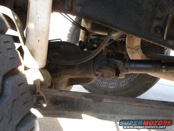 Undercarriage view of a truck's driveshaft and suspension components