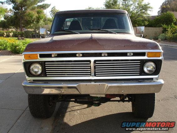 Front view of a brown 1977 Ford F-150 with a chrome grille