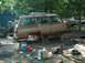 1996 Ford F-250 - A disassembled Jeep Grand Wagoneer sits outdoors, surrounded by parts and tools, awaiting repair.