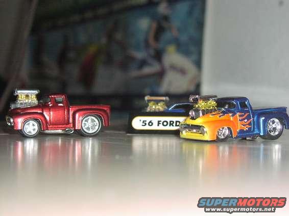 Red and blue toy trucks with exposed engines and flame decals