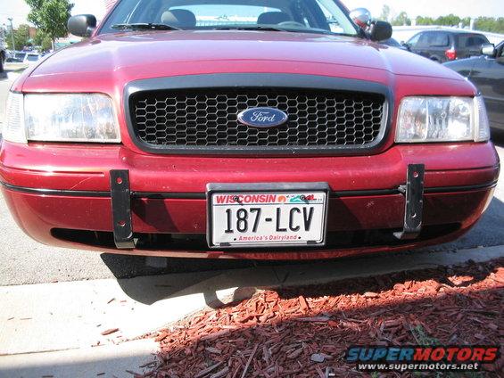 Got my plates that week too!

Brackets were small but would have to remove the bumper to remove them. Plus I found that something had impacted the left side hard enough to bent the braket and tear the bumper cover. So hiding the cuts with moulding wasn't an option.
So onto eBay I went.... 