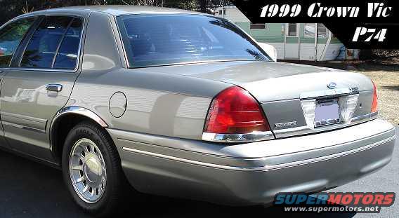 Silver sedan rear quarter view. Chrome trim, tinted windows, and a visible gas cap
