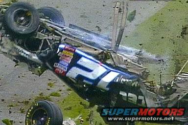 Race car upside down with visible "57" and "SUPERMOTORS" logo