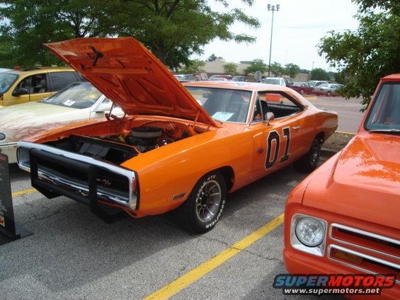 Orange 1969 Dodge Charger with "01" on door, hood open, Confederate flag emblem