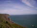 1989 Ford Bronco - A scenic view of a coastline meeting the vast ocean on a clear day.