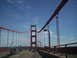 1989 Ford Bronco - Driving across the Golden Gate Bridge with traffic and cyclists visible.