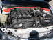 1992 Ford Taurus - The engine bay of a silver car, a V6 engine and a red strut bar.