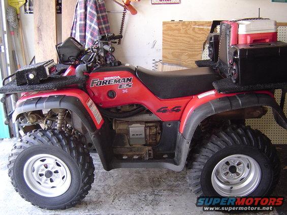 Red 2006 Honda Foreman ES ATV with black racks, a cooler, and speakers