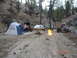 1996 Ford Bronco - Multiple off-road vehicles and tents are set up at a campsite with a roaring campfire.