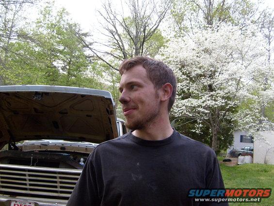 Truck with hood open, showing engine bay. Grille is visible