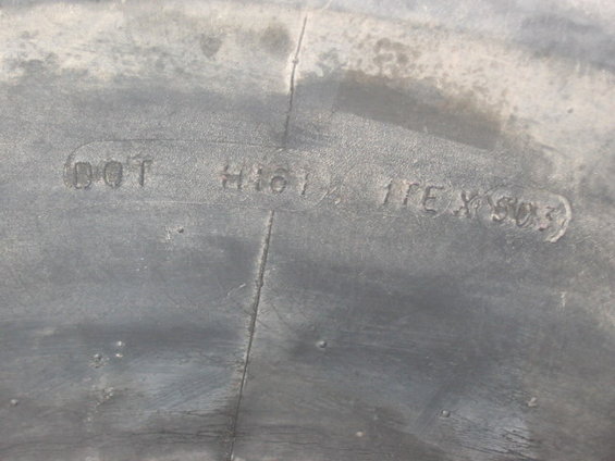 Close-up of tire sidewall showing DOT markings and size information