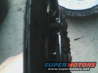 Close-up of a black car part with Supermotors.net watermark