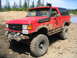 1979 Ford Bronco - This red SUV, likely a 1987 Ford Bronco, is equipped for off-road adventures with a snorkel and large tires.