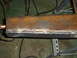 1989 Ford Bronco - A close-up view of a metal beam that has been welded, with a copper pipe extending from one end.