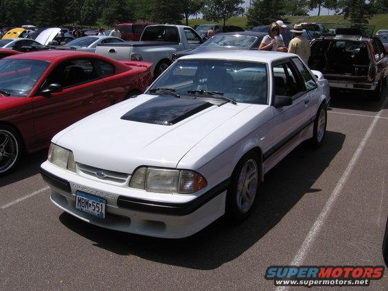 White 1989 Ford Mustang coupe with black hood scoop and license plate MBM-551