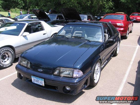 Dark blue 1989 Ford Mustang parked in a lot with other cars