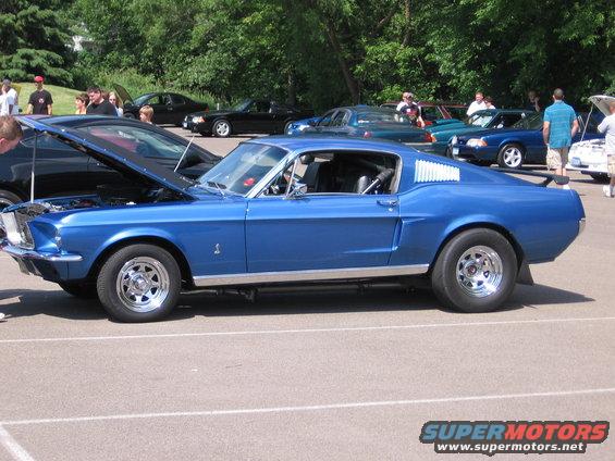 Blue classic Ford Mustang with louvers on the rear quarter window