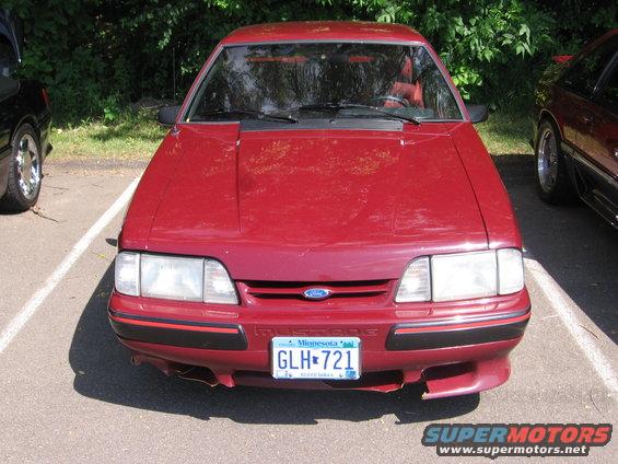 Red 1989 Ford Mustang front view with Minnesota license plate GLH-721