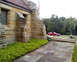 1993 Ford Probe - A red 1993 Ford Probe is visible from the side, parked near a stone building with an American flag.