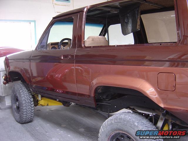 Brown 1986 Ford Bronco II side view, interior visible