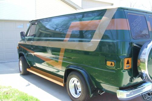 1978 Ford E250 van, green with gold and brown stripe graphics, wood trim, and spare tire on rear
