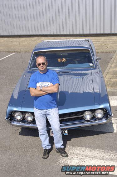 Blue 1970 Ford Ranchero with a man standing in front, front view