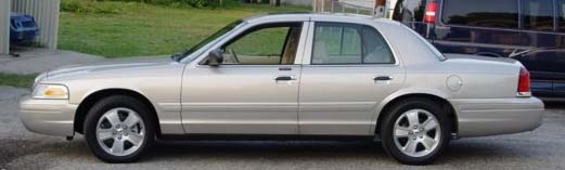 Silver 1996 Ford Crown Victoria sedan, side view