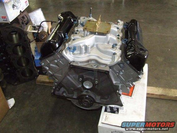 V8 engine block and intake manifold on a pallet. Another engine block is to the left