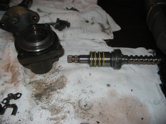 Disassembled steering rack and pinion components on a white cloth