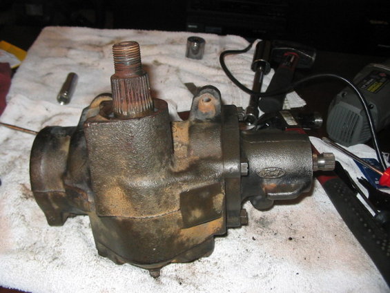 Ford steering gear box on a white cloth with tools nearby