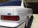 1995 Ford Taurus - Rear view of a white 1995 Ford Taurus sedan parked in a garage.