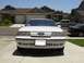 1995 Ford Taurus - White 1995 Ford Taurus front view, parked in a suburban driveway with other vehicles present.
