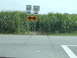 1995 Mercury Grand Marquis - Roadside signs indicate Indiana routes 68 and 161, with a large cornfield bordering the road.