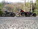 1995 Mercury Grand Marquis - Three Harley-Davidson motorcycles are parked in a row on the side of a road, with a scenic wooded hillside in the background.