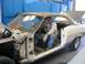 1973 Ford Ranchero - A man sits in the driver's seat of a 1966 Ford Ranchero undergoing restoration, showing its disassembled state.