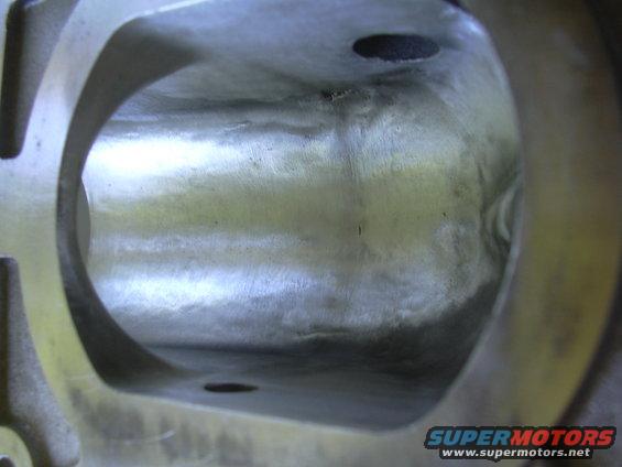 Close-up of the interior of a metal engine intake manifold plenum