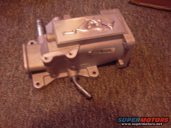 Aluminum plenum with a Ford Mustang horse emblem embossed on top