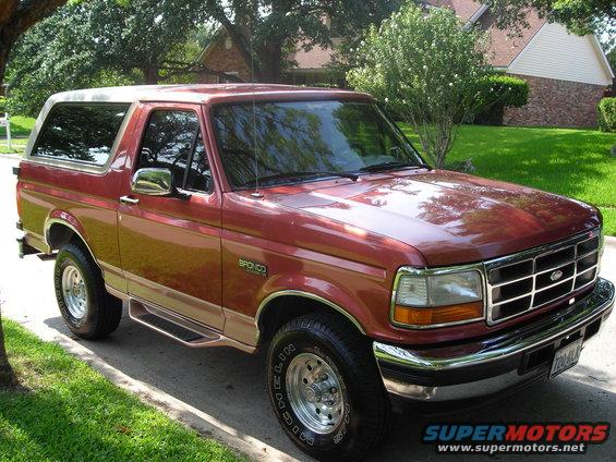1995 Ford Bronco parked on a residential street, front 3/4 view
