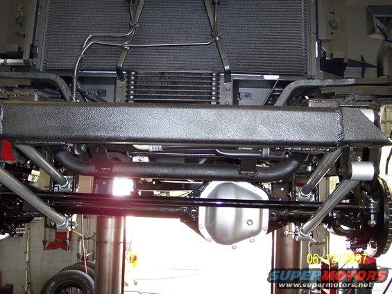 Undercarriage view showing suspension components, differential, and radiator assembly