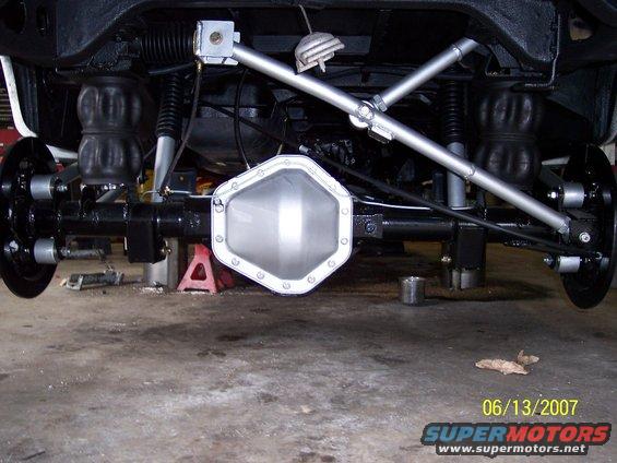 Rear axle assembly with air springs and shock absorbers visible