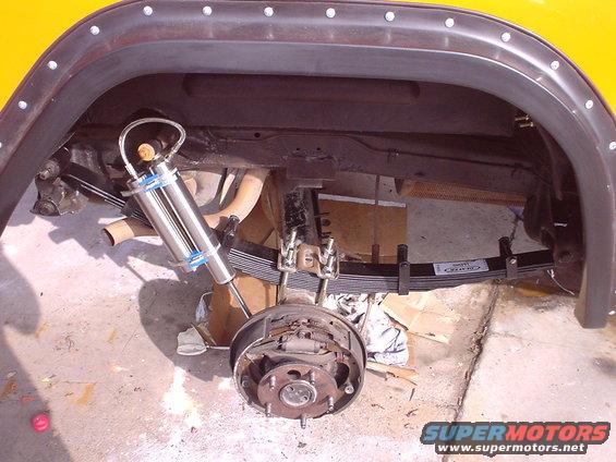 Rear suspension of a 1977 Ford Bronco showing leaf springs and a new shock absorber