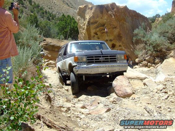 1987 Ford Bronco navigating a rocky trail