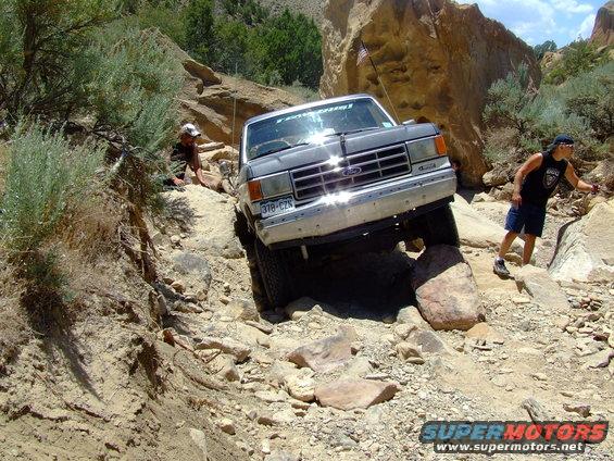 Gray 1987 Ford Bronco navigating rocky terrain