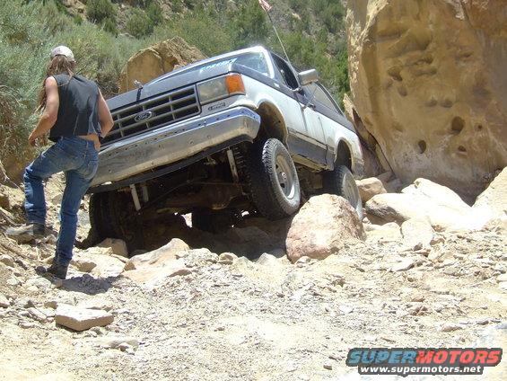 1987 Ford Bronco navigating a rocky trail