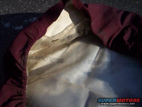 Maroon car cover interior with visible text 'CAMBRIA' and 'SUPERMOTORS.NET' watermark