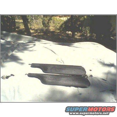 Two dark sun visors on a white tarp