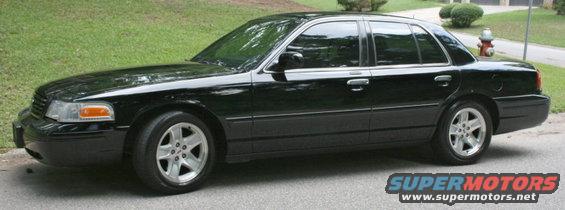 Black 2002 Ford Crown Victoria sedan parked on a street