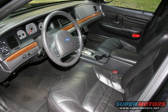 Interior of a 2002 Ford Crown Victoria showing leather seats, dashboard, steering wheel, and center console