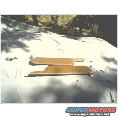 Two tan sun visors laid out on a tarp